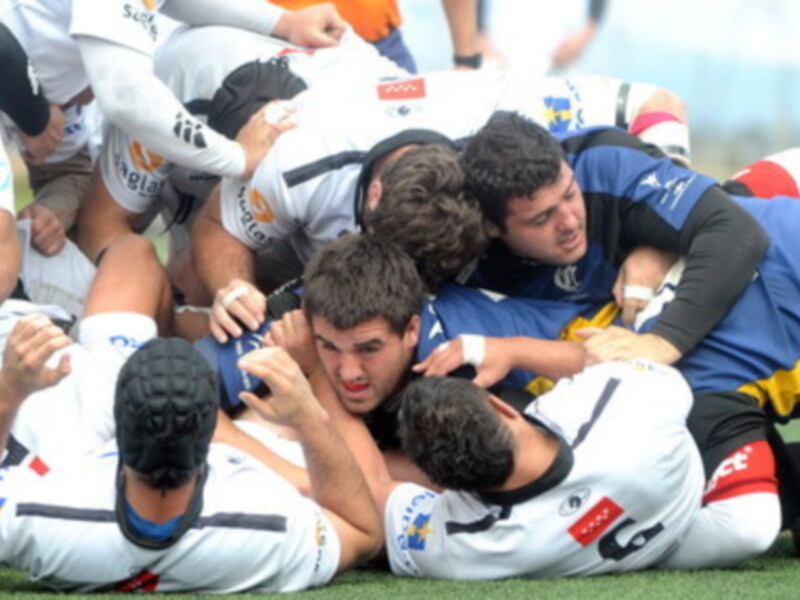 Jugadores de rugby en una scrum durante un partido.