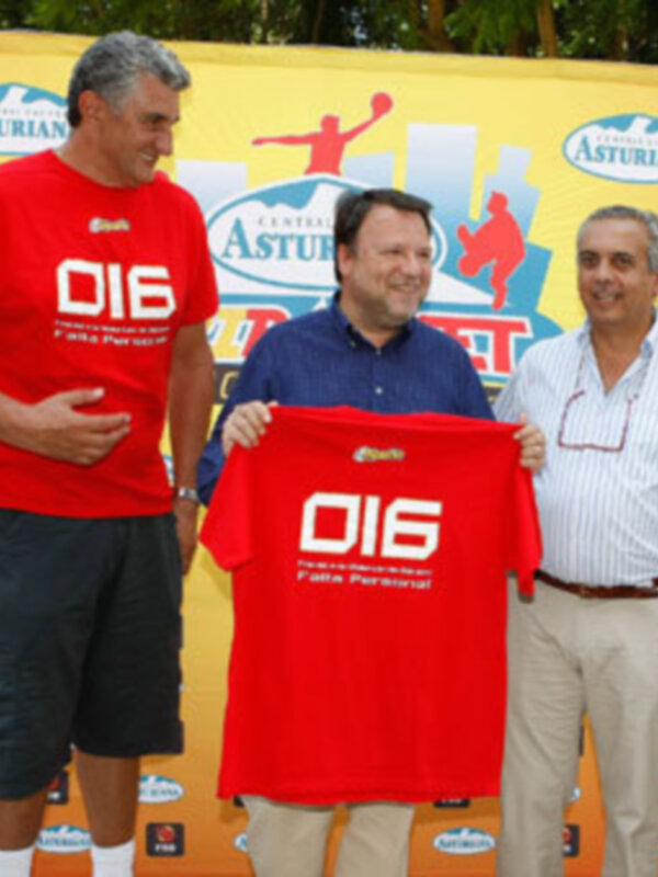 Tres personas posan con una camiseta roja que dice '016' frente a un fondo con el logo 'Asturiana'.