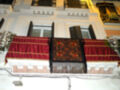 Balcony adorned with red and gold fabrics and floral decorations, illuminated at night.