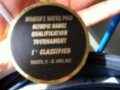 Medalla de oro con texto: "WOMEN'S WATER POLO OLYMPIC GAMES QUALIFICATION TOURNAMENT 1° CLASSIFIED TRIESTE, 15 - 22 APRIL 2012".