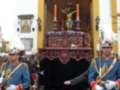 Imagen muestra una procesión religiosa con soldados en trajes tradicionales y un altar con el Cristo crucificado.