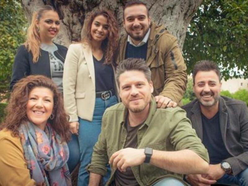 Grupo de amigos sonrientes en un parque, disfrutando de un día soleado.