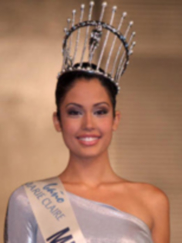 Miss Universe participant wearing a crown and sash, representing her country with elegance.