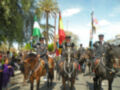 Hombres en uniforme militar montando caballos con banderas de España y la India.