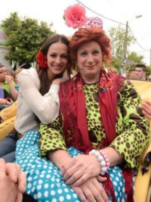 Dos personas en trajes coloridos y divertidos, posando para la foto.