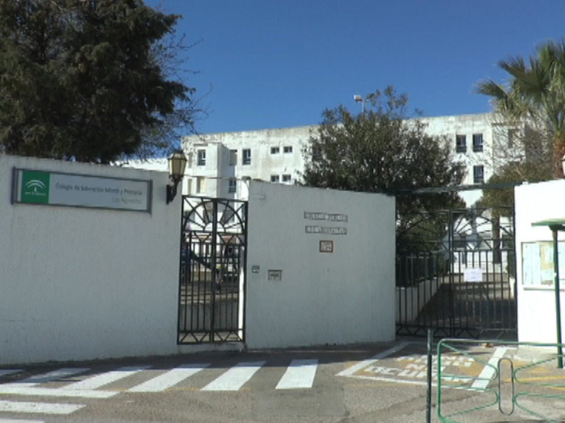 Puerta principal de una institución educativa con un cartel informativo y una señalética clara.